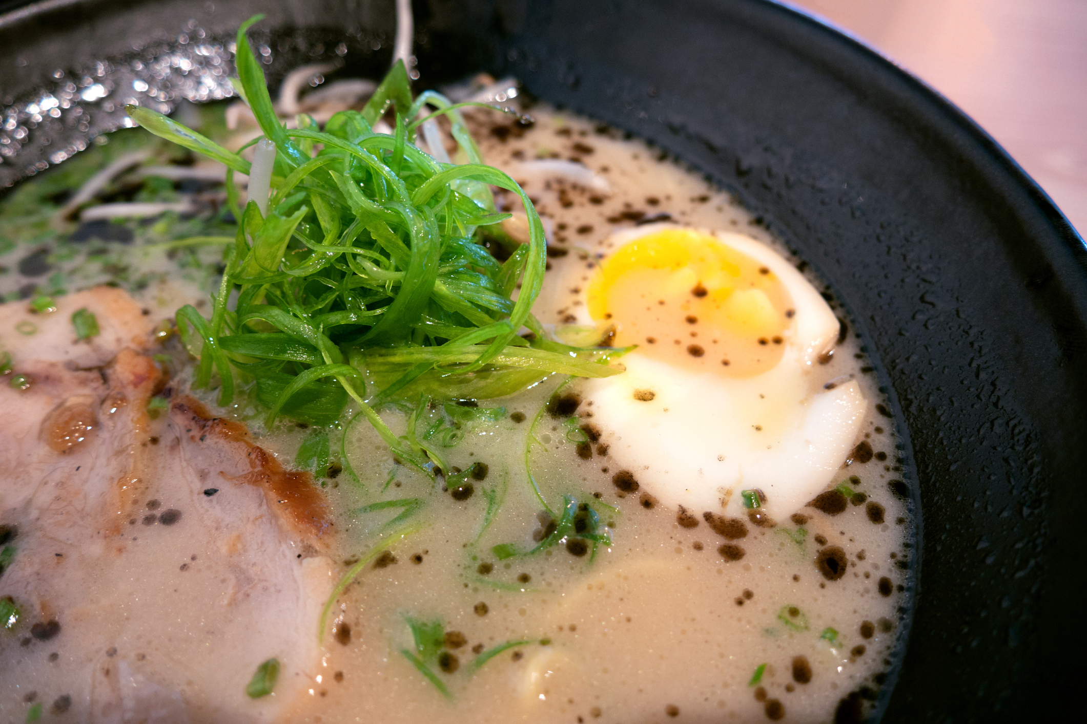 Photo of Japanese ramen with egg and pork, closeup