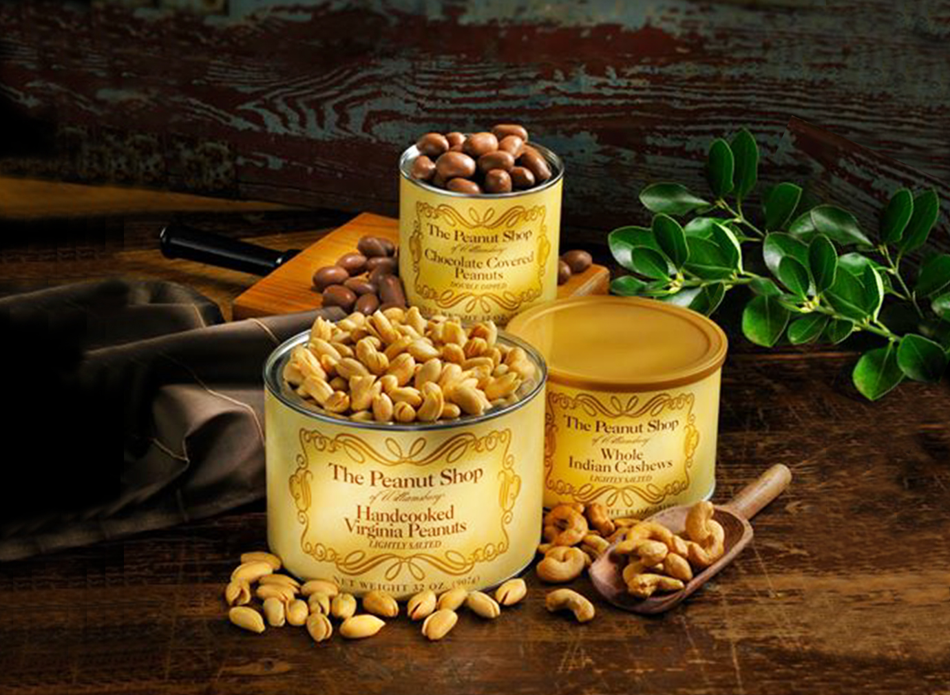 Three jars of peanuts staged on a dark wood background